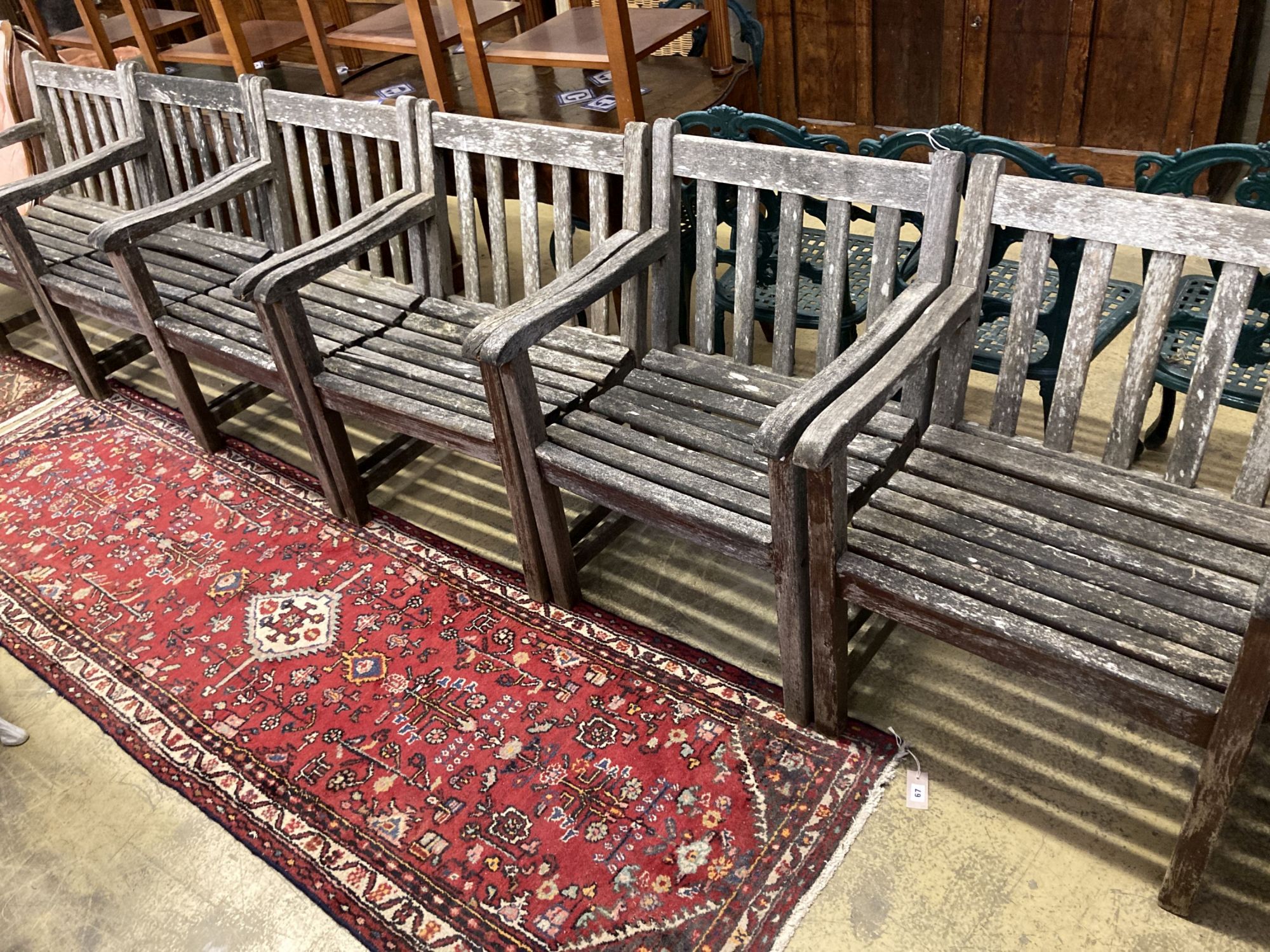 A set of six weathered teak elbow chairs, width 62cm, depth 58cm, height 85cm